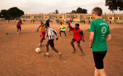 A Projects Abroad volunteer work with teens to teach football in Ghana. A sports player gains experience through volunteer football coaching in Ghana.